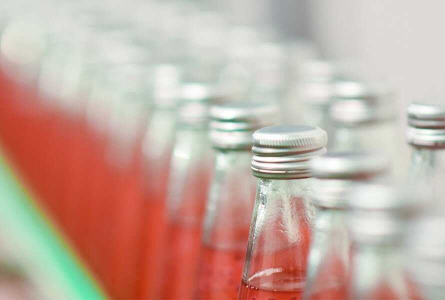 Rows of glass beverage bottles